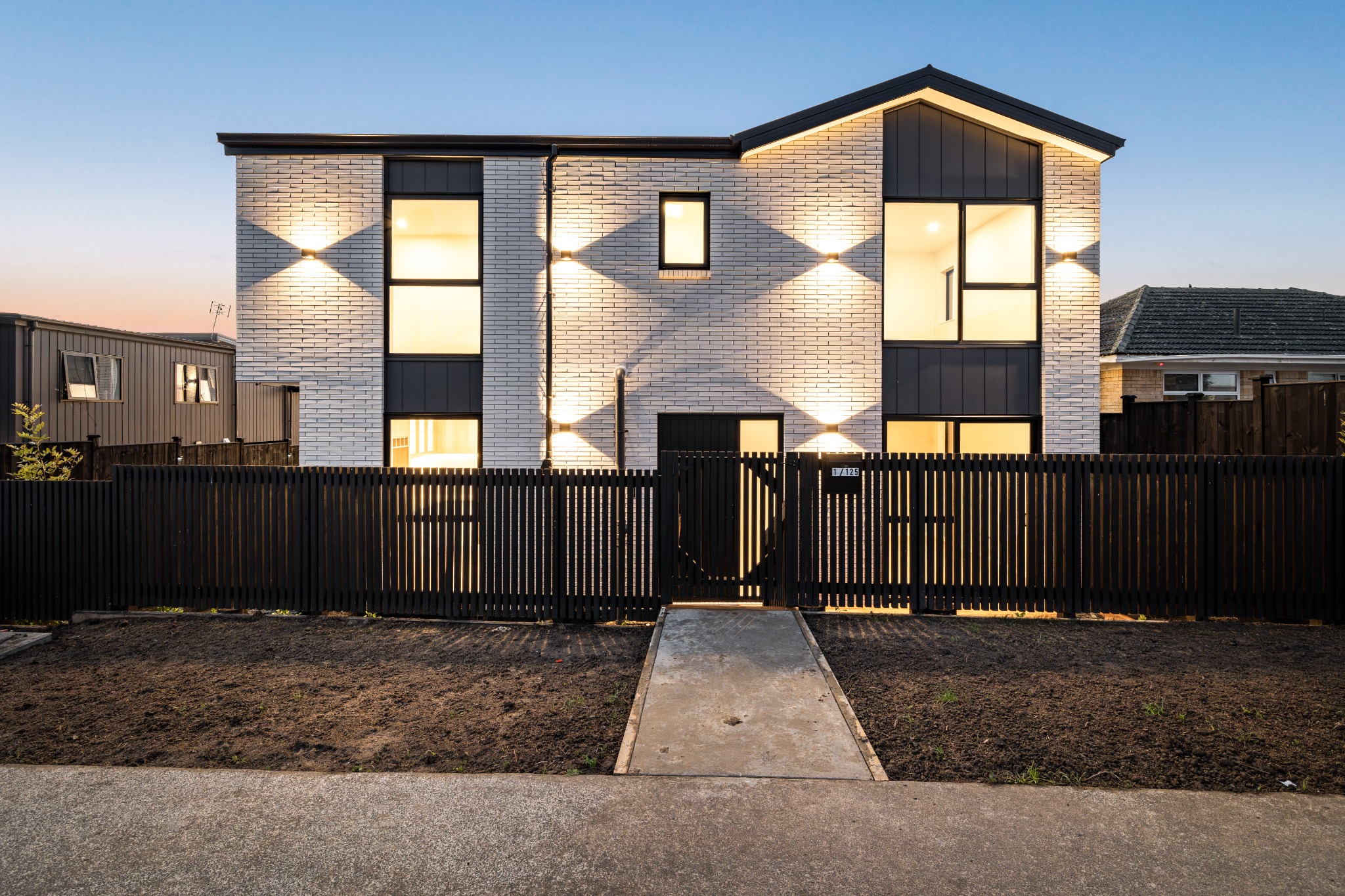 125 Ridge Road residences illuminated at dusk in Howick